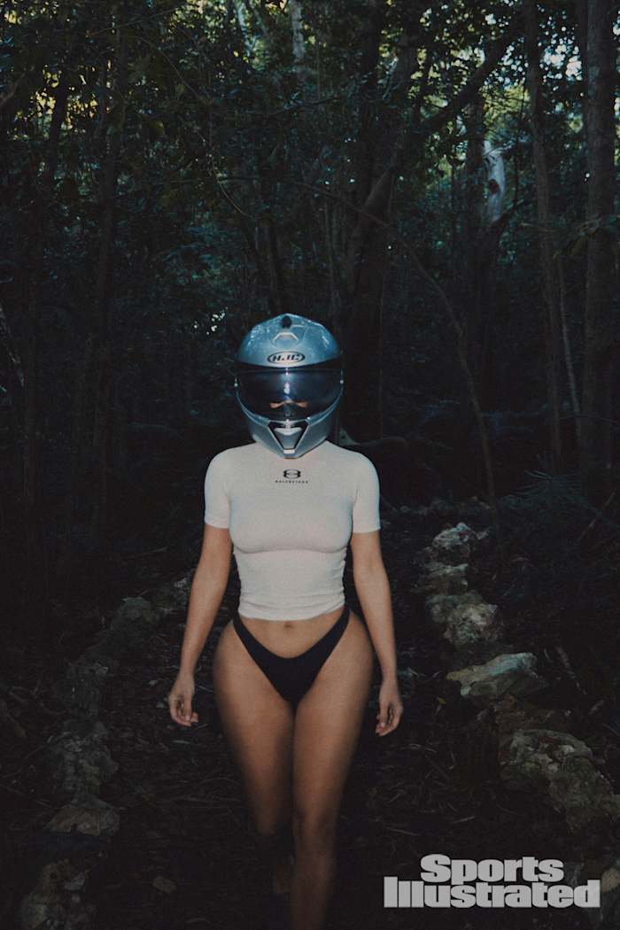 Kim Kardashian was photographed by Greg Swales in the Dominican Republic. Swimsuit by SKIMS. Top by Balenciaga. Helmet by HJC.